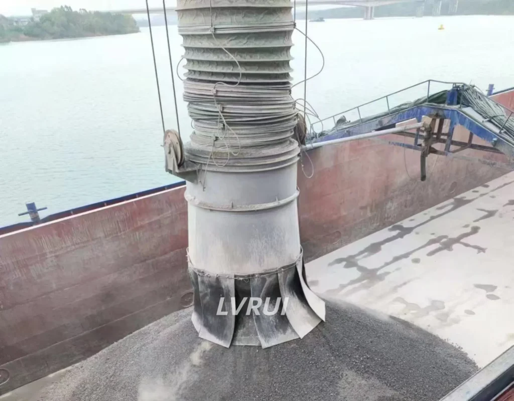 Close-up of a telescopic ship loading spout discharging bulk material into a ship hold